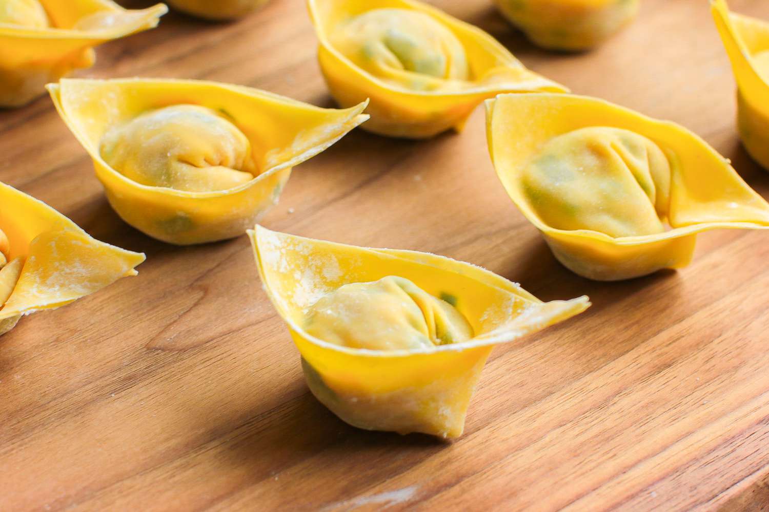 Tael Shaped Pork and Chive Dumplings on a Cutting Board
