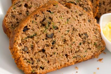 Slices of freshly baked zucchini bread served with butter