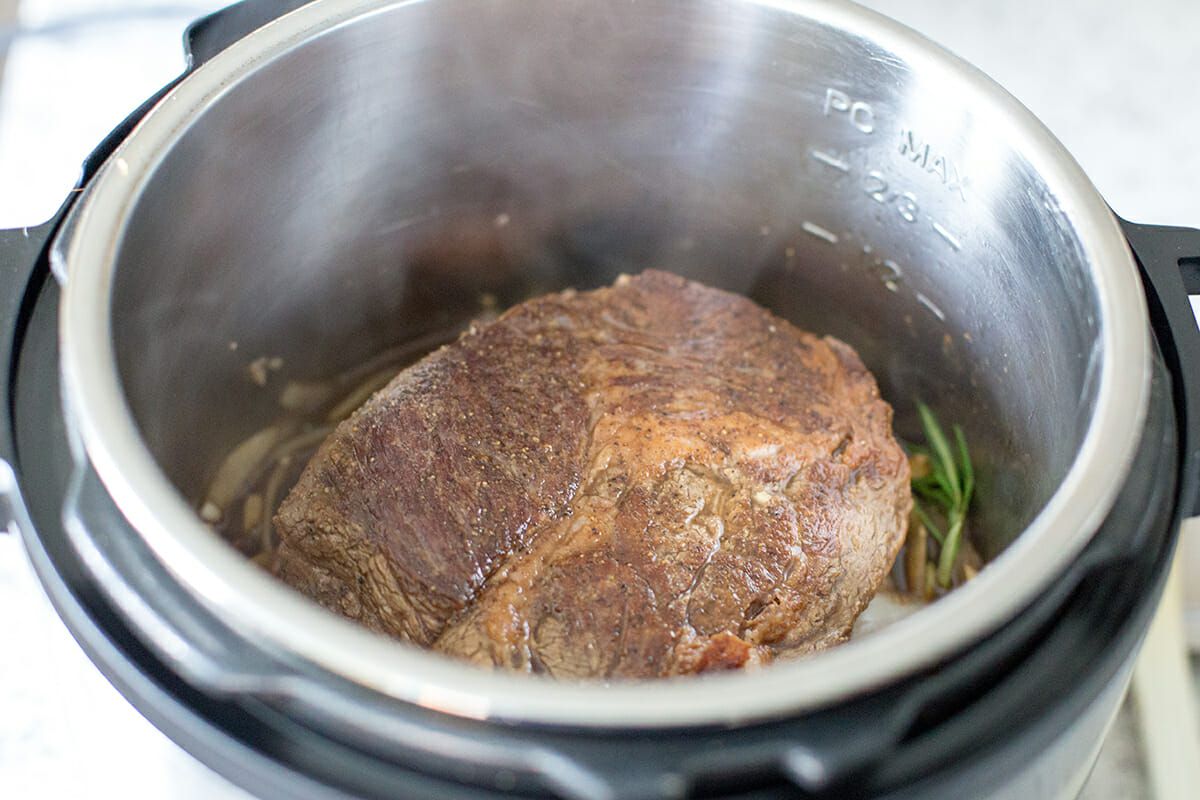 Nestle the chuck roast into the instant pot