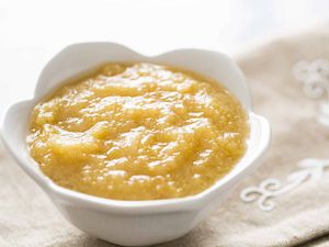 A bowl of homemade Applesauce in a white bowl