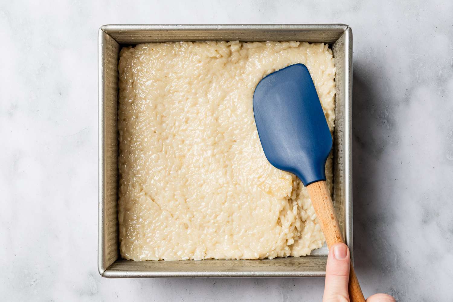 biko added to greased baking pan for biko (Filipino sticky rice cake) recipe