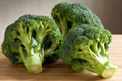 Broccoli florets on a wooden surface