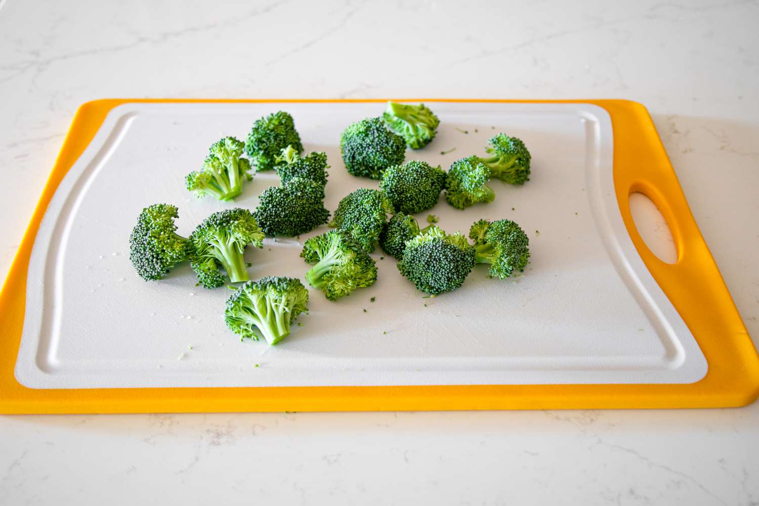 Broccoli Cut into Florets on a Cutting Board for How to Blanch Broccoli