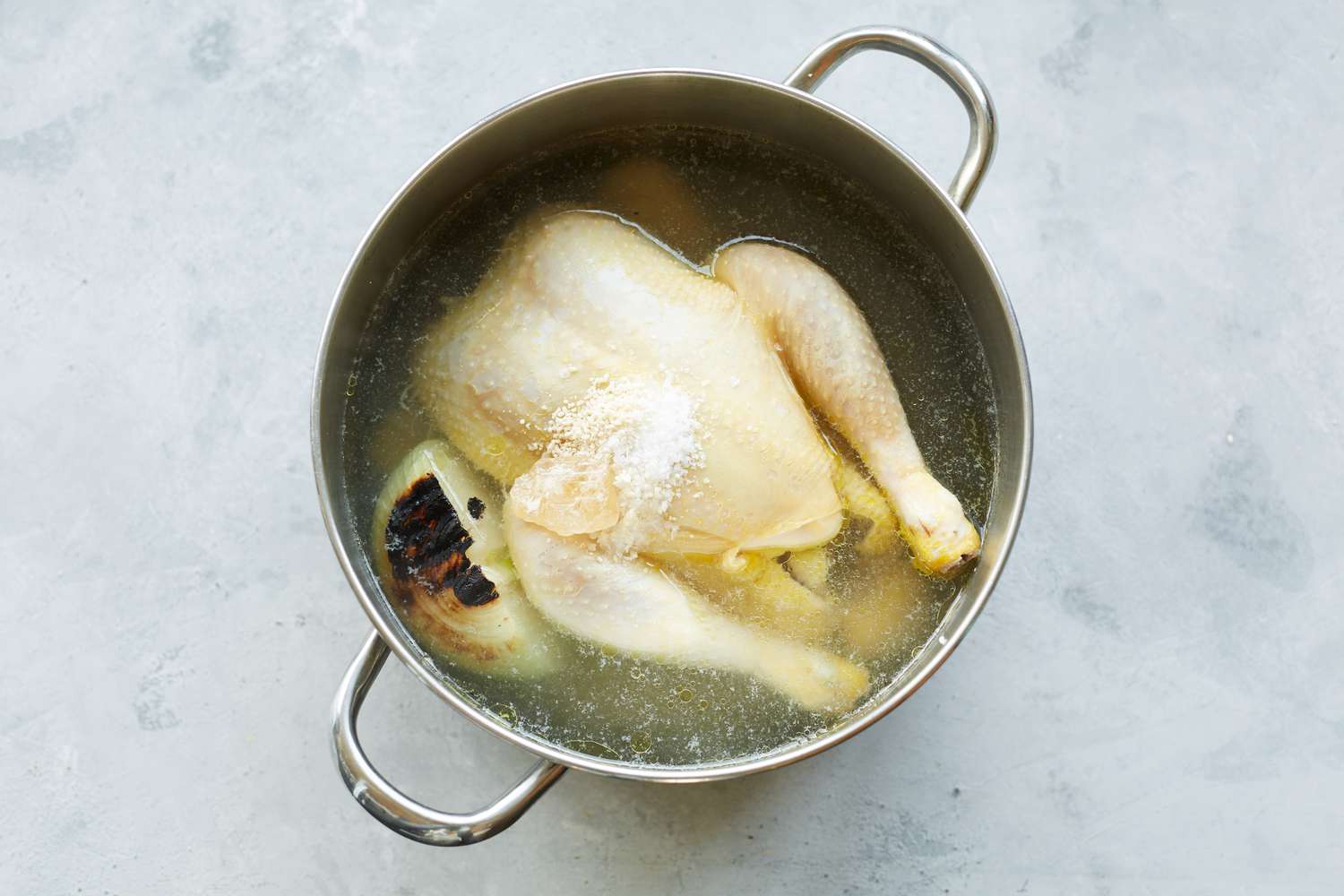 Whole Chicken and Onion in Pot with Water for Vietnamese Rice Porridge Recipe