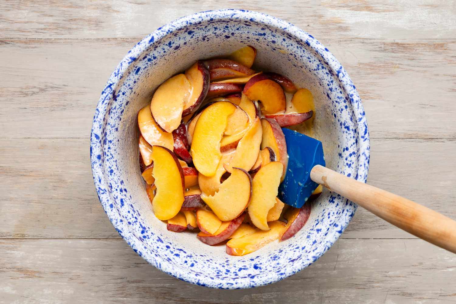 Sliced peaches mixed together with sugar, egg, and spices