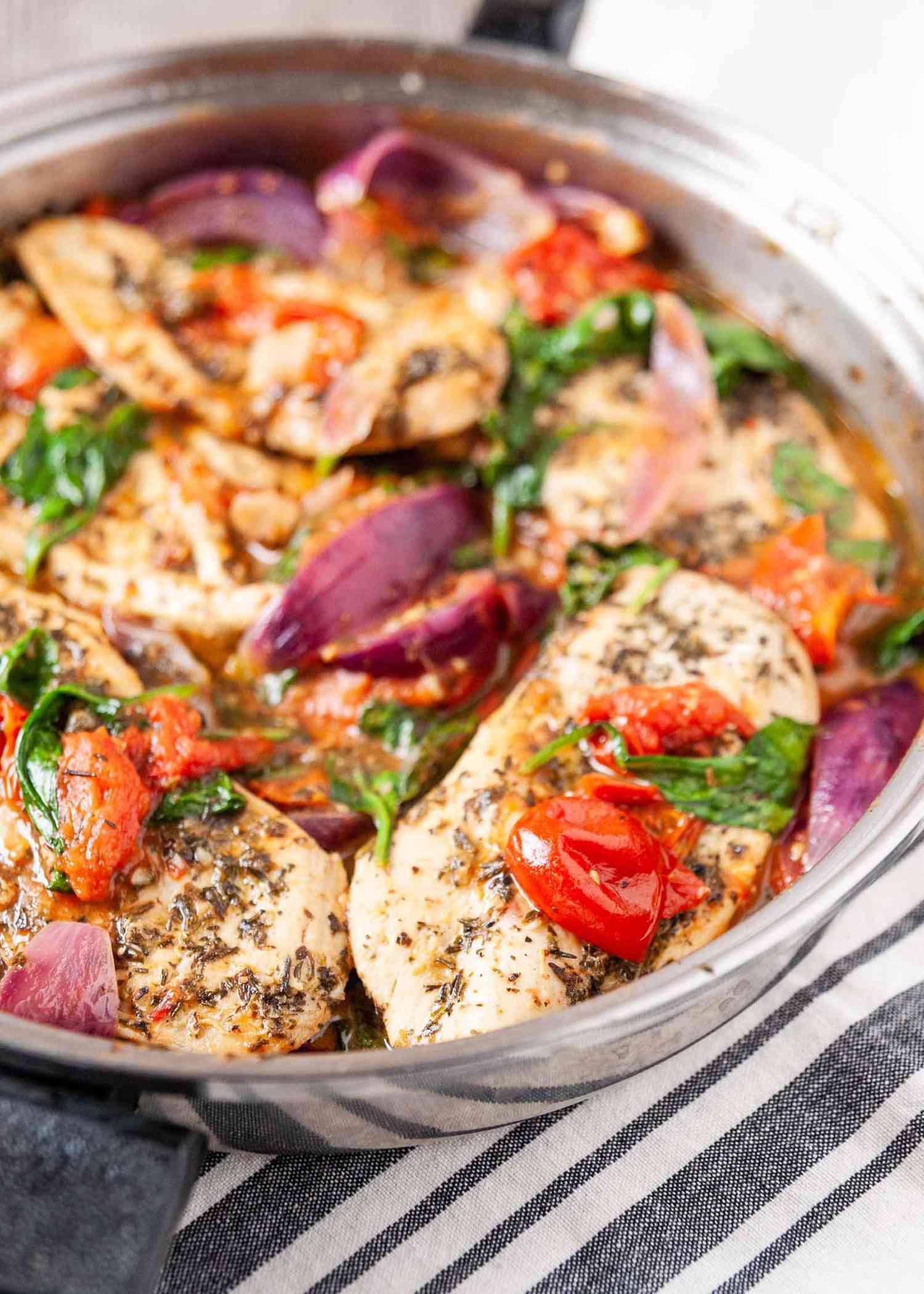 Chicken Recipe in Skillet with Italian Seasonings-close up of chicken and vegetables in a silver skillet