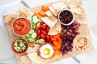 Dips vegetables fruit and olives for mediterranean mezze platter