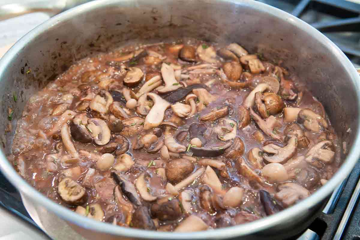 mushrooms in red wine in pan