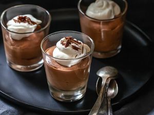 Easy chocolate mousse in serving glasses and set on a tray.
