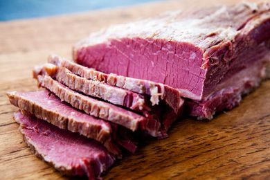 Home cured corned beef sliced on a cutting board
