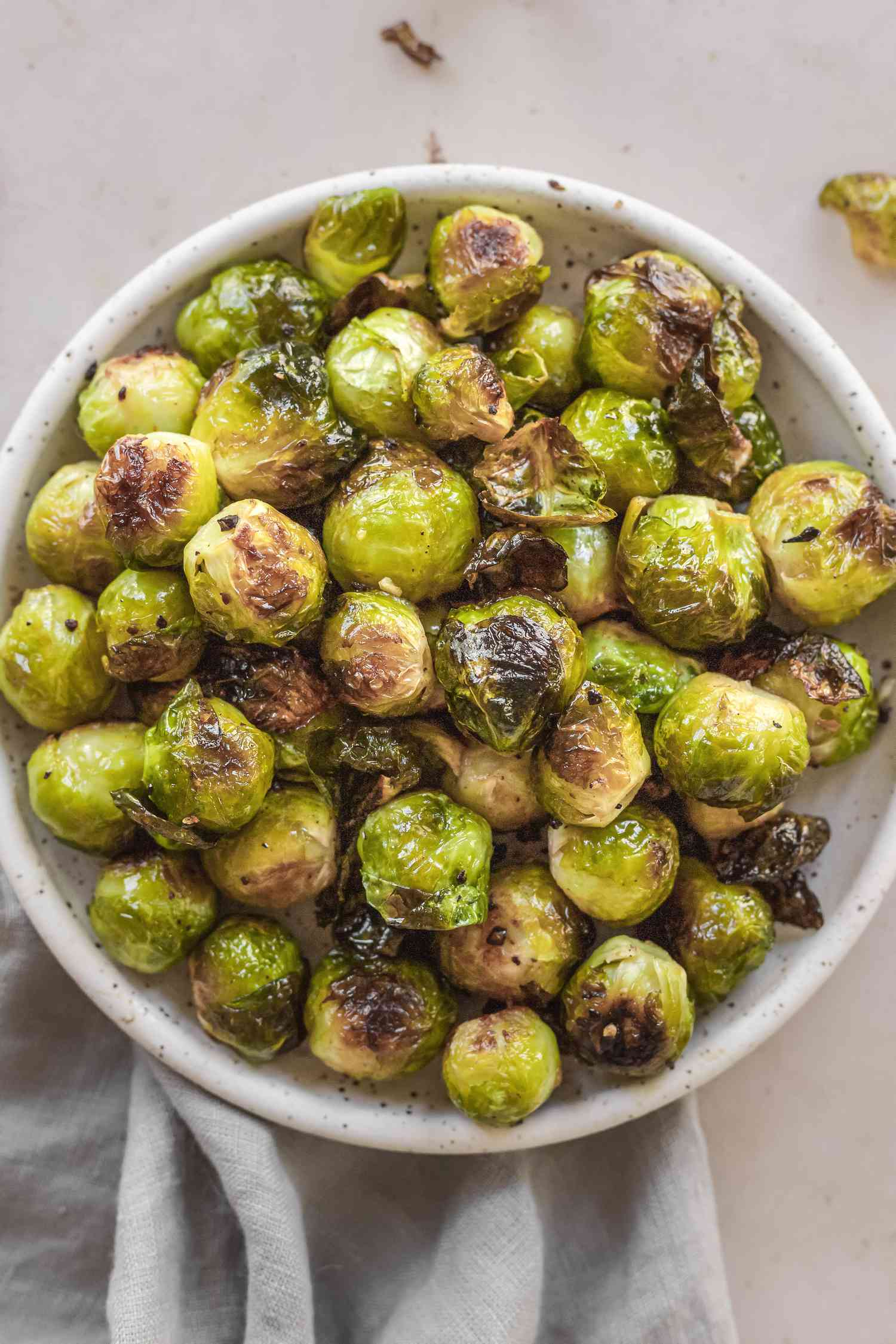 Overhead view of a serving dish of oven roasted brussel sprouts.