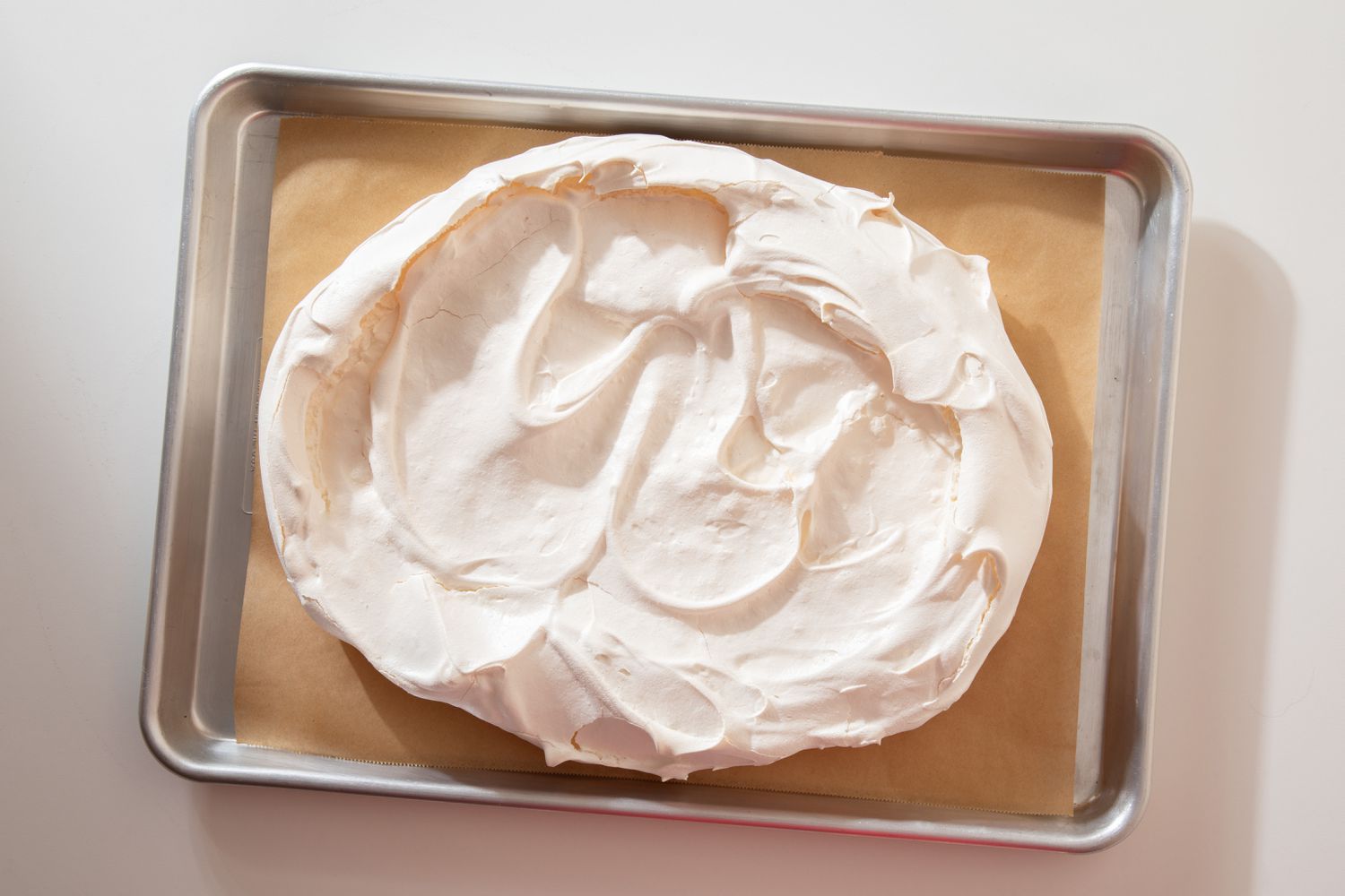 baked meringue layer on the baking sheet for berry pavlova recipe