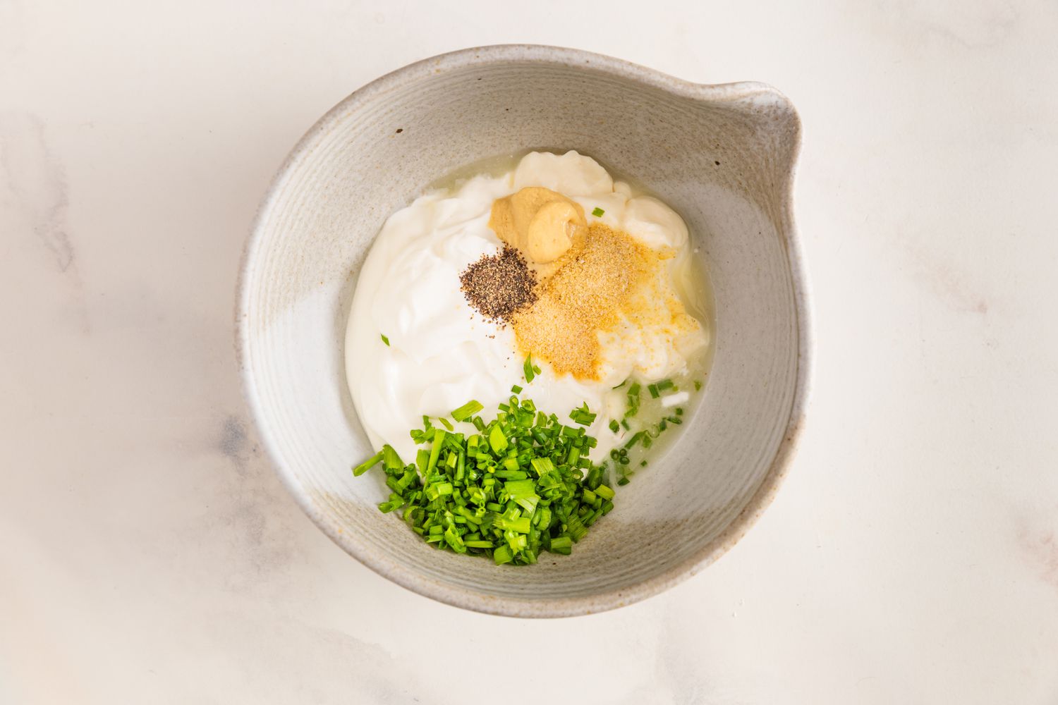 Bowl of Sour Cream & Onion Dressing Ingredients (Sour Cream, Chives, and Spices)