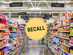 Looking down a grocery store aisle. A "recall" badge is superimposed over the center of the photo.