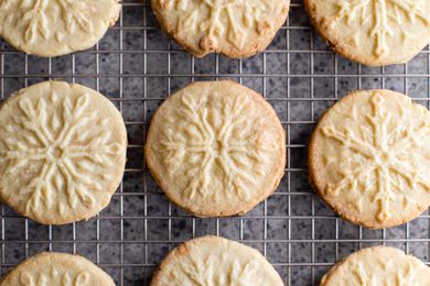 Almond-flavored butter cookies on a baking sheet.