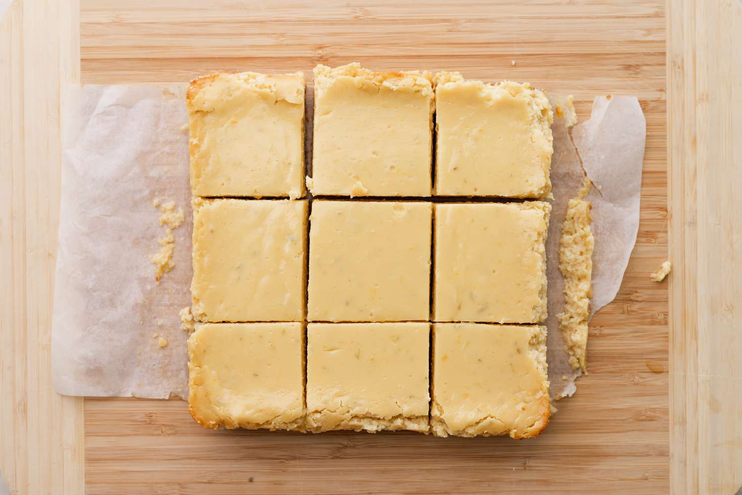 Cut key lime bars on wooden cutting board