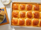 Flaky salt sprinkled onto salted honey rolls (still in the baking pan on the cooling rack)