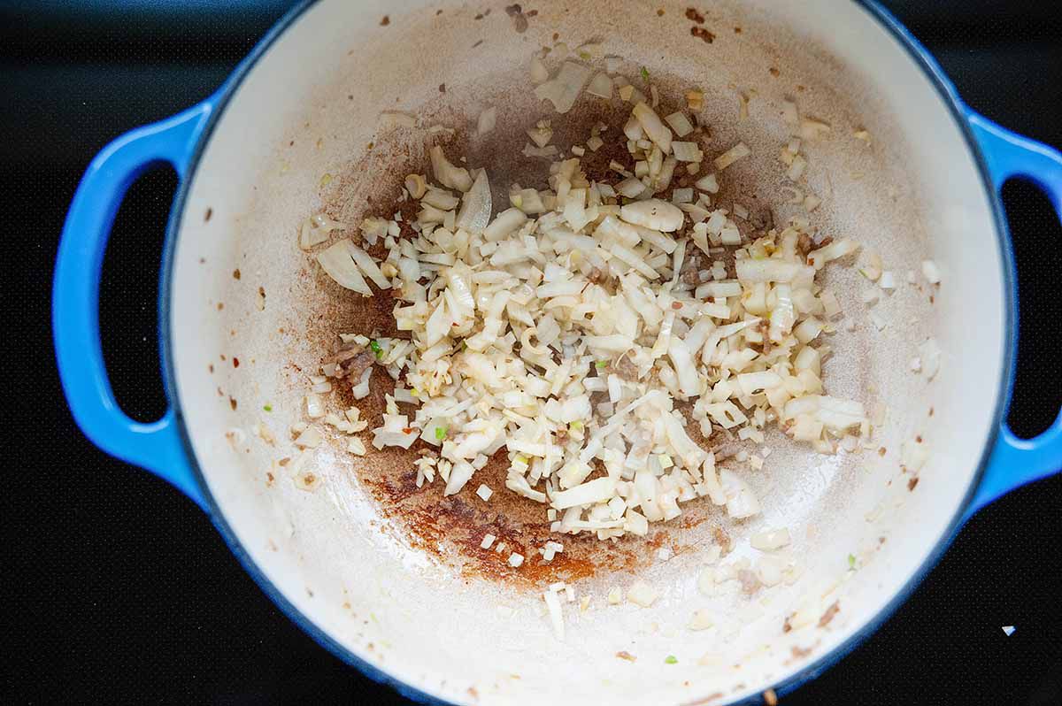 Creamy Tomato Tortellini Soup - cooking sausage and onions in a pot