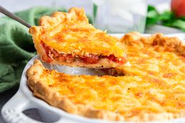 Tomato Pie with a Slice Lifted on a Pie Knife