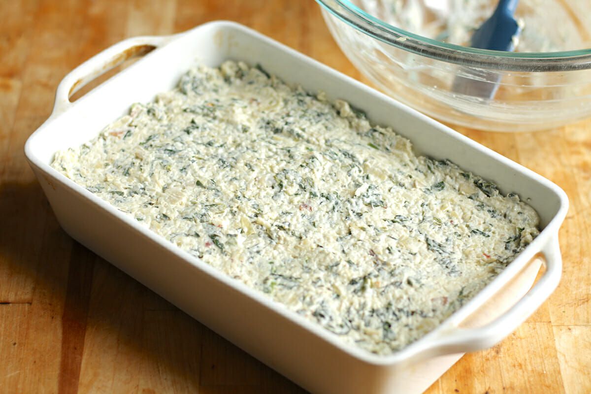 Spinach Artichoke Dip in casserole dish ready to bake