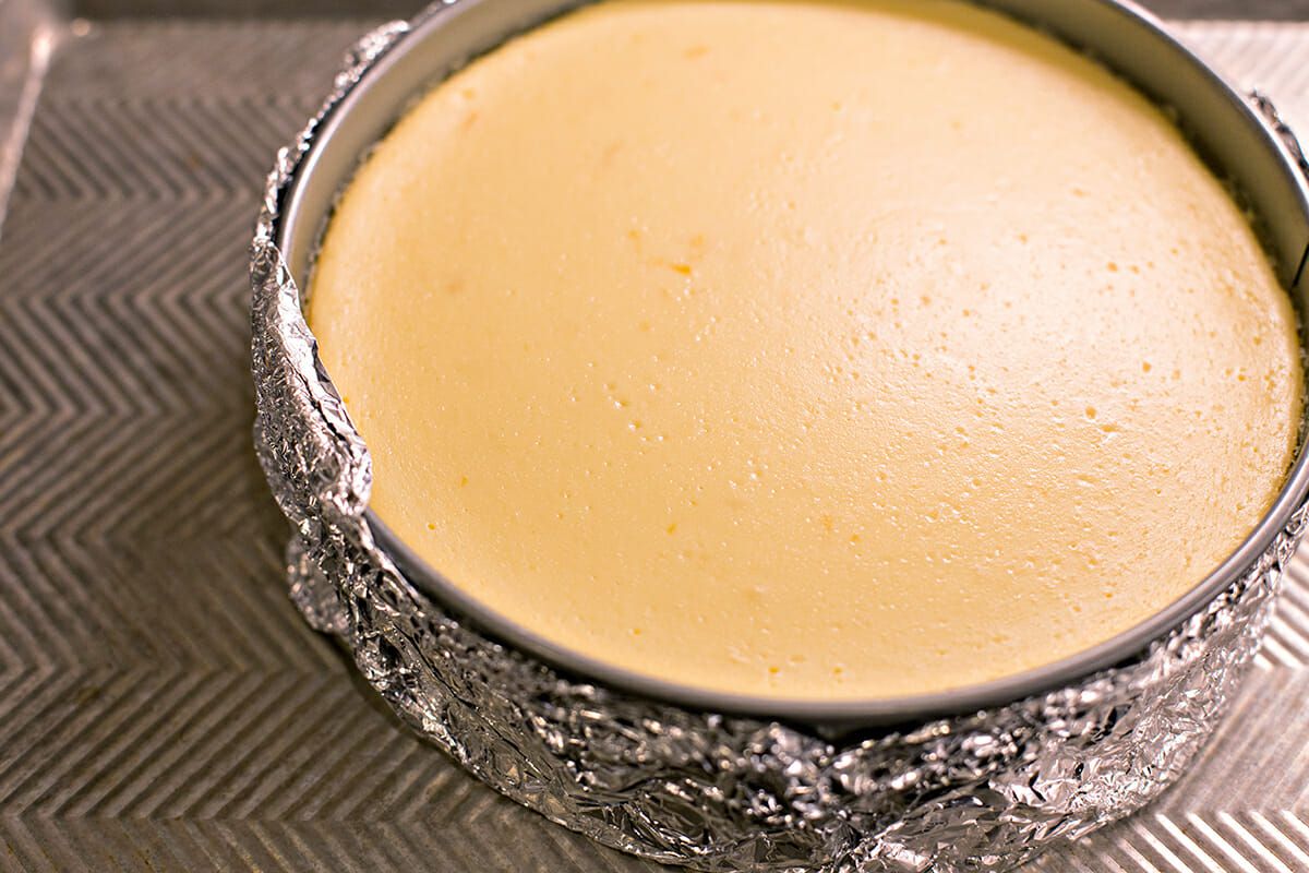 Lemon cheesecake cooling on a baking sheet