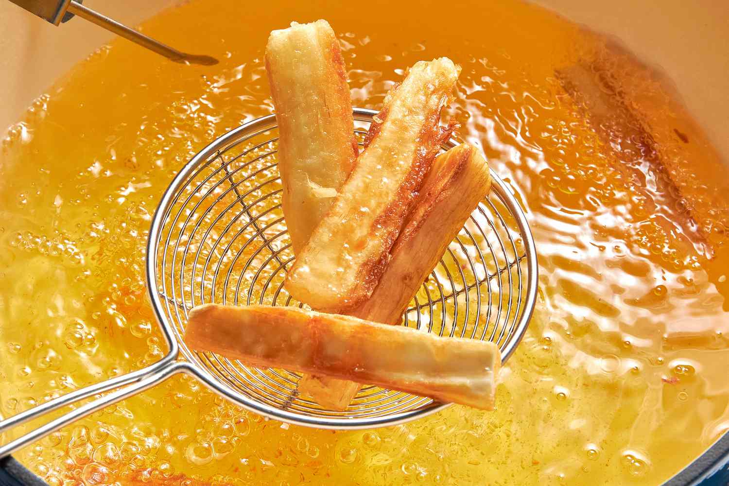 Yuca Fries Removed From Hot Oil Using a Spider Strainer