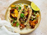 Plate of Tacos al Pastor with Pork, Pineapple, Cilantro, and a Lime Wedge 