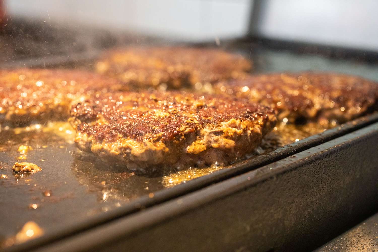 How to make smashburgers with four patties on a griddle.