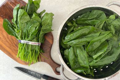 Washed Spinach Drained in Colander for Vegan Creamed Spinach