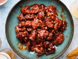 Korean fried chicken on blue platter. 