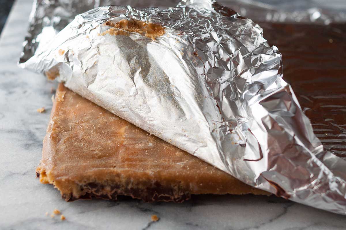 Foil being peeled back to reveal the Christmas cracker candy underneath 