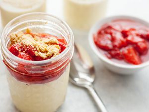 Sous vide cheesecake in a jar topped with strawberries