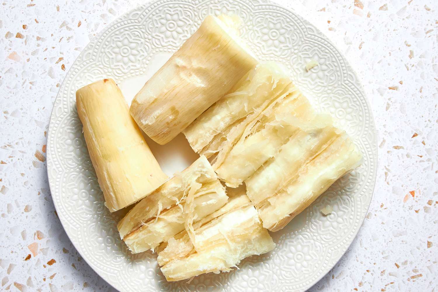 Boiled Yuca on a Plate: One With the Fibrous Core Removed and Two Still Intact