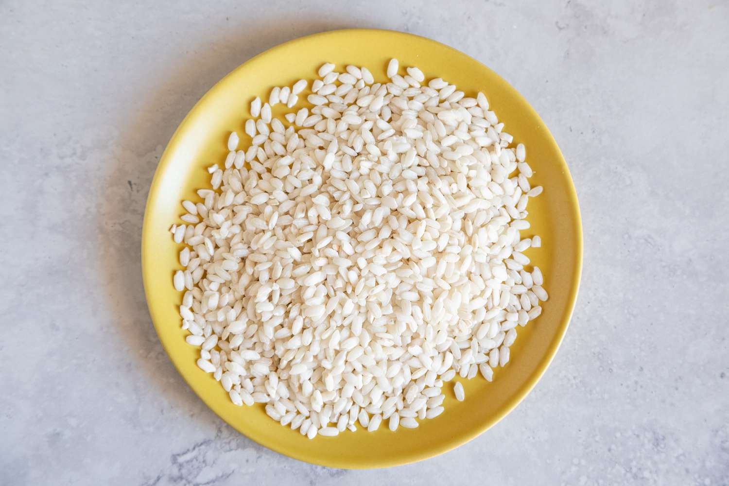 Arborio rice on yellow plate