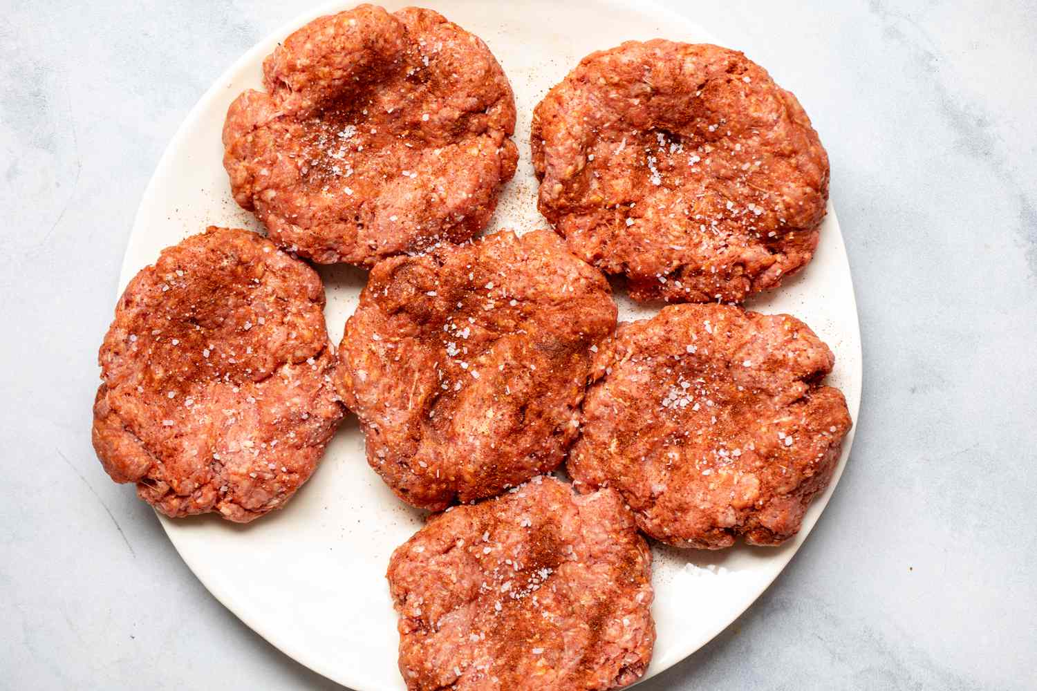 Patties on a plate to make a Nacho burger recipe.