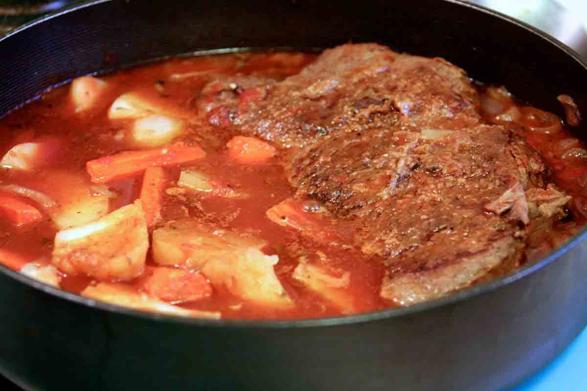 Vegetables added and cooking with the Swiss steak