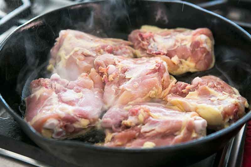 browning chicken thighs in a skillet