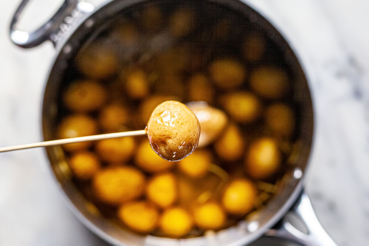 Check potatoes for doneness with a skewer.