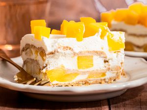 slice of mango float (mango royale) on a plate (close-up, cross-section cut facing forward)