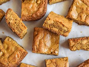 Overhead view of blonde brownies scattered on a counter