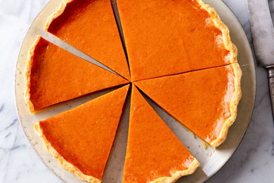 A pumpkin pie cut into several slices
