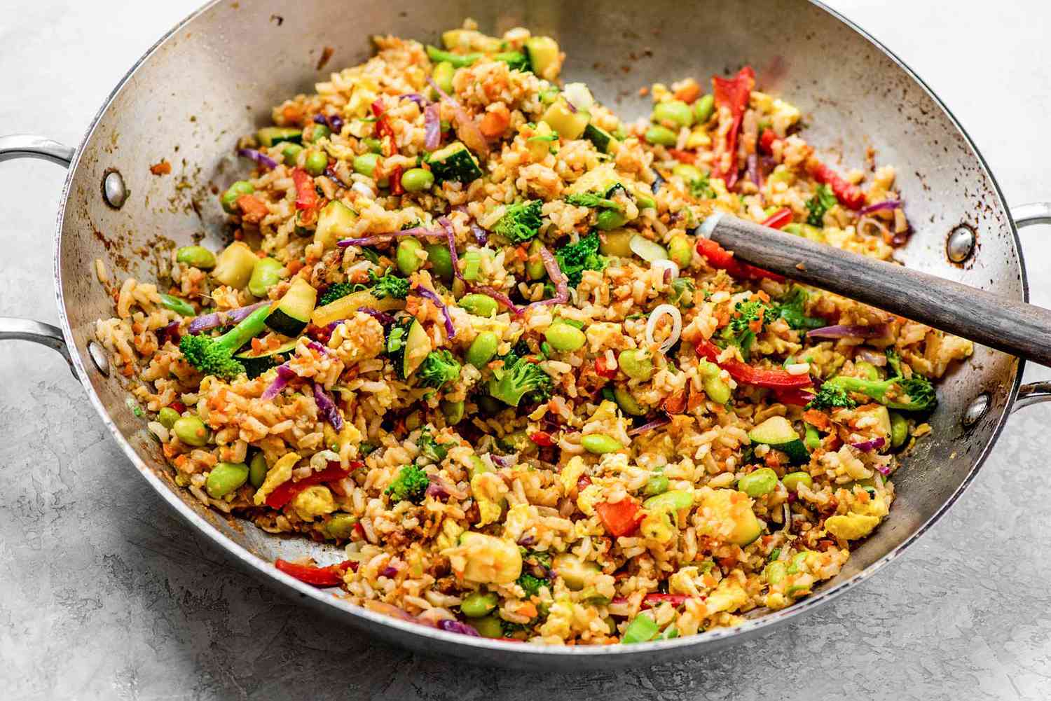 A large wok filled with vegetable fried rice
