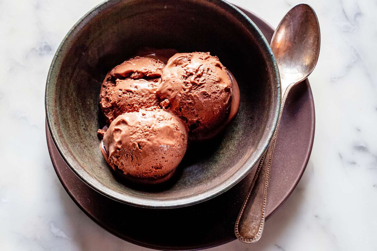 Overhead view of scoops mexican hot chocolate in a bowl.