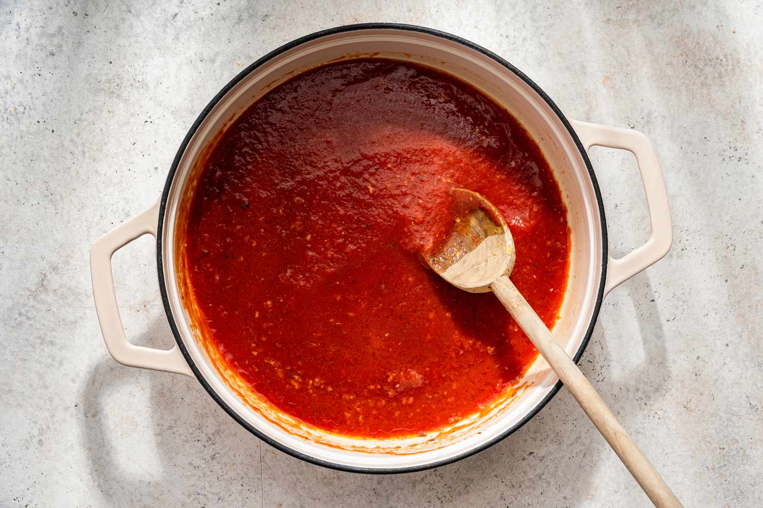 Tomato sauce added to the pot with the heated garlic for assassin's spaghetti recipe