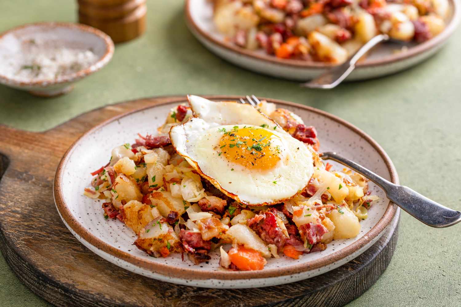 plate of breakfast hash with a fried egg on top
