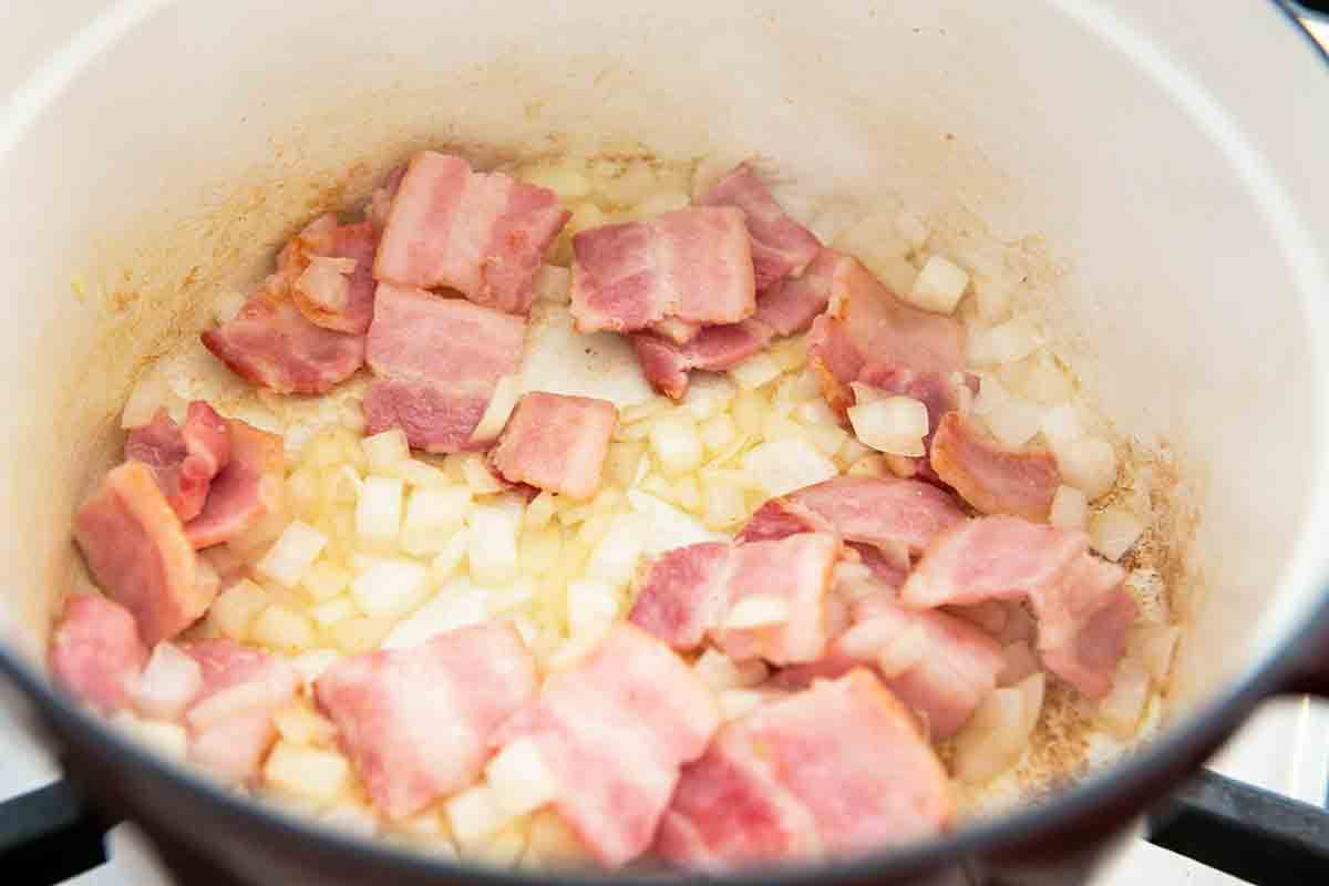 add onions and garlic to bacon in pot