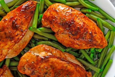 golden brown baked chicken breast with green beans