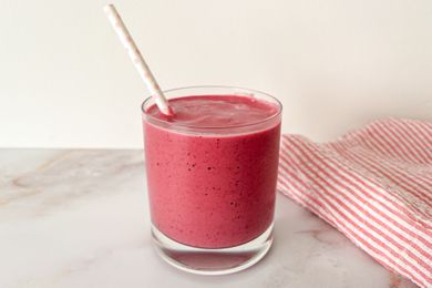 3-ingredient smoothie in a short glass with a white paper straw with light pink polka dots