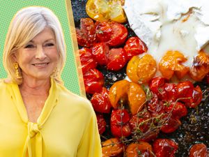 Martha Stewart next to a plate of roasted tomatoes and cheese