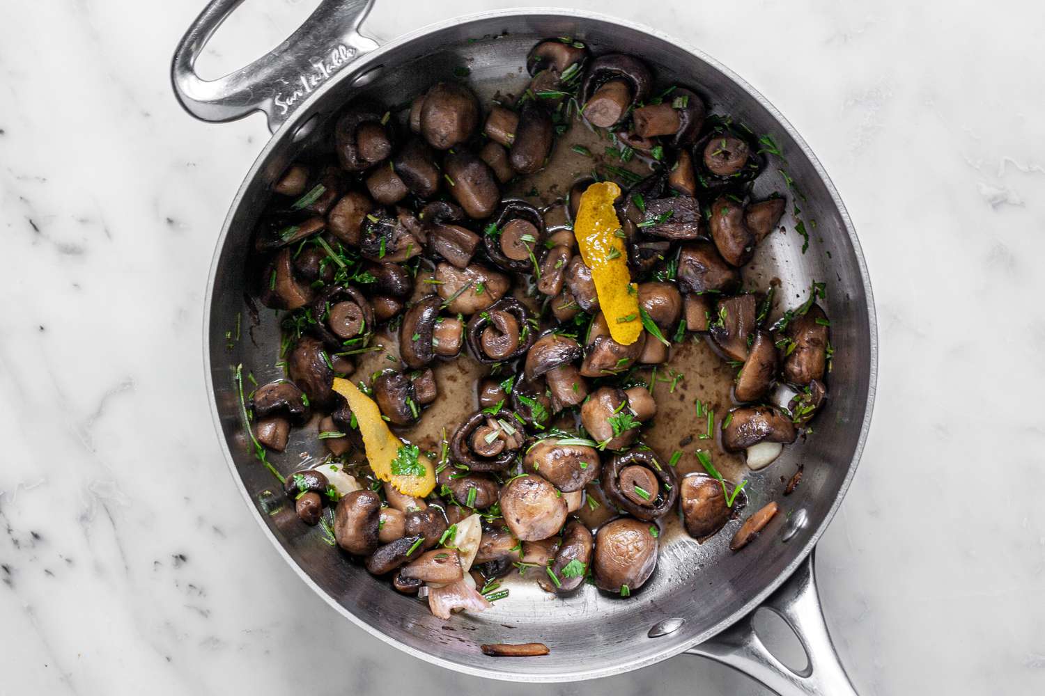 Marinated Mushrooms with Herbs and Lemon Peel in a Pot